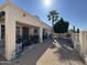Home exterior with shaded patio, desert landscaping, palm tree, and fence at 6214 E Sierra Morena St, Mesa, AZ 85215