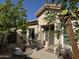 Charming single-story home featuring mature landscaping, front door and patio table at 6214 E Sierra Morena St, Mesa, AZ 85215
