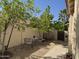 Landscaped side yard features mature trees, gravel, and outdoor furniture at 6214 E Sierra Morena St, Mesa, AZ 85215