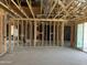 Open-concept living room framing, showing exposed beams and natural light from a sliding glass door at 7603 W Avenida Del Rey --, Peoria, AZ 85383