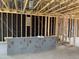 Living room framing with exposed beams, showing electrical wiring and a partially built wall at 7603 W Avenida Del Rey --, Peoria, AZ 85383