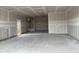 Spacious garage with a neutral interior awaits customization, offering ample room for vehicles and storage at 7736 W Coyote Dr, Peoria, AZ 85383