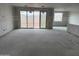 Bright living room with large sliding doors, ready for your personal touch at 7736 W Coyote Dr, Peoria, AZ 85383