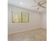 Comfortable bedroom with tile flooring, a ceiling fan, and natural light, offering a serene atmosphere at 9802 N 77Th St, Scottsdale, AZ 85258