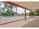 View of backyard featuring a covered patio overlooking the sparkling pool surrounded by desert landscaping at 9802 N 77Th St, Scottsdale, AZ 85258