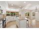 Bright kitchen with white cabinetry, granite countertops, and an island, complemented by natural light from large windows at 9802 N 77Th St, Scottsdale, AZ 85258