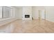 Spacious living room with a corner fireplace, large window, and tiled floors at 9802 N 77Th St, Scottsdale, AZ 85258