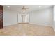 Open-concept living area with tile flooring and an arched doorway, offering a versatile space for relaxation and entertaining at 9802 N 77Th St, Scottsdale, AZ 85258