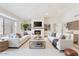 Bright living room with a modern fireplace, built-in shelves, and neutral-toned furniture at 9802 N 77Th St, Scottsdale, AZ 85258