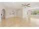 Open living room with tile flooring, ceiling fan, and natural light, creating a spacious and inviting atmosphere at 9802 N 77Th St, Scottsdale, AZ 85258