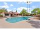 Backyard features a large swimming pool with a spacious deck and mature trees around the perimeter at 9802 N 77Th St, Scottsdale, AZ 85258