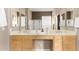 Bright bathroom featuring double sinks, updated fixtures, and a walk-in shower behind decorative glass blocks at 15140 E Staghorn Dr, Fountain Hills, AZ 85268