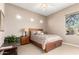 Comfortable bedroom with neutral colors, large window, ceiling fan, and tile floors offering a relaxing retreat at 15140 E Staghorn Dr, Fountain Hills, AZ 85268