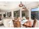 Bright dining room featuring a large table and chairs, views of the backyard, and a view into the kitchen at 15140 E Staghorn Dr, Fountain Hills, AZ 85268