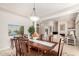 Bright dining room with a large table, statement lighting, and views into the living room at 15140 E Staghorn Dr, Fountain Hills, AZ 85268