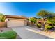 Inviting home with a spacious two-car garage and a beautifully landscaped front yard and desert plants at 15140 E Staghorn Dr, Fountain Hills, AZ 85268