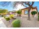Welcoming home showcasing professional desert landscaping, mature trees, and a charming facade at 15140 E Staghorn Dr, Fountain Hills, AZ 85268