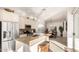 This bright kitchen has an island, stone countertops, and stainless appliances, with the dining room in the background at 15140 E Staghorn Dr, Fountain Hills, AZ 85268