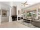 Spacious living room with a fireplace, ceiling fan, and ample natural light at 15140 E Staghorn Dr, Fountain Hills, AZ 85268