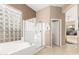 Bright and open main bathroom featuring a bathtub, glass-enclosed shower, and block windows for light at 15140 E Staghorn Dr, Fountain Hills, AZ 85268