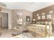 Large main bedroom featuring decorative neutral walls, a brass bed frame, and a doorway to the main bathroom at 15140 E Staghorn Dr, Fountain Hills, AZ 85268
