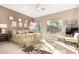 Spacious main bedroom with a decorative ceiling fan, neutral walls, and large windows with a lush backyard view at 15140 E Staghorn Dr, Fountain Hills, AZ 85268