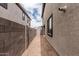 Long, narrow backyard with neutral colored walls for privacy and minimal landscaping opportunities at 15587 S 180Th Ln, Goodyear, AZ 85338