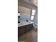 Bathroom with wood look flooring, double vanity, and a separate toilet at 15587 S 180Th Ln, Goodyear, AZ 85338