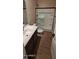 Bathroom features modern fixtures, wooden plank flooring, and a glass enclosed shower at 15587 S 180Th Ln, Goodyear, AZ 85338