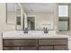 Bathroom with double sink vanity and large mirror and dark wood cabinets at 15587 S 180Th Ln, Goodyear, AZ 85338