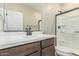 Bathroom with vanity, mirror, brown cabinets, toilet, and tiled standing shower at 15587 S 180Th Ln, Goodyear, AZ 85338