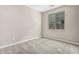 Neutral bedroom with a window providing natural light and neutral carpet flooring at 15587 S 180Th Ln, Goodyear, AZ 85338