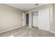 Cozy bedroom featuring a closet with sliding doors and neutral walls at 15587 S 180Th Ln, Goodyear, AZ 85338