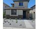 Charming two-story home with a stone-accented facade and low-maintenance landscaping at 15587 S 180Th Ln, Goodyear, AZ 85338