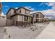 Well-maintained exterior with stone accents, a gravel front yard, and landscaping that enhances curb appeal at 15587 S 180Th Ln, Goodyear, AZ 85338