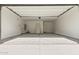 An empty two car garage with white walls and concrete floors ready to be customized for your needs at 15587 S 180Th Ln, Goodyear, AZ 85338