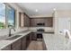 The kitchen has stainless steel appliances, granite counters, and wood-look tile flooring at 15587 S 180Th Ln, Goodyear, AZ 85338