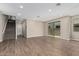 Generous living area featuring wood-look tile floors, a staircase, and direct access to the backyard at 15587 S 180Th Ln, Goodyear, AZ 85338