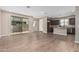 Open-concept space blending living and dining areas, featuring wood-look tile and sliding glass door at 15587 S 180Th Ln, Goodyear, AZ 85338