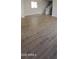 Open living room features wood-look tile, a staircase, and natural light at 15587 S 180Th Ln, Goodyear, AZ 85338