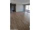 Spacious living area with wood-look tile flooring and sliding glass doors at 15587 S 180Th Ln, Goodyear, AZ 85338