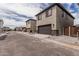 Two story homes with neutral color schemes, two car garages, and minimal landscaping on a sunny day at 15587 S 180Th Ln, Goodyear, AZ 85338