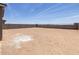 A spacious dirt backyard, ready for a buyer to add landscaping and personalization at 17561 W Pierson St, Goodyear, AZ 85395