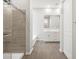 Well-lit bathroom with shower, tub, and modern vanity at 17561 W Pierson St, Goodyear, AZ 85395