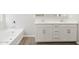 Bathroom featuring a tub and vanity with drawers and cabinets at 17561 W Pierson St, Goodyear, AZ 85395