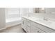 Bathroom featuring double sink vanity, soaking tub, and modern fixtures at 17561 W Pierson St, Goodyear, AZ 85395