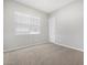 Neutral bedroom with carpet, a window and a door at 17561 W Pierson St, Goodyear, AZ 85395