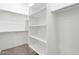 Walk in closet with shelving and clothes rod, with neutral carpet at 17561 W Pierson St, Goodyear, AZ 85395