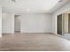 Open-concept living area with sliding glass doors and tile flooring. Ready for your personal touch at 17561 W Pierson St, Goodyear, AZ 85395