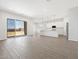 Open-concept living area boasts wood-look tile floors and a sliding glass door to the backyard at 17561 W Pierson St, Goodyear, AZ 85395